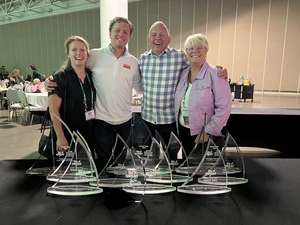 Leadership with the Main Sail award trophies at the 2024 Great Clips Convention